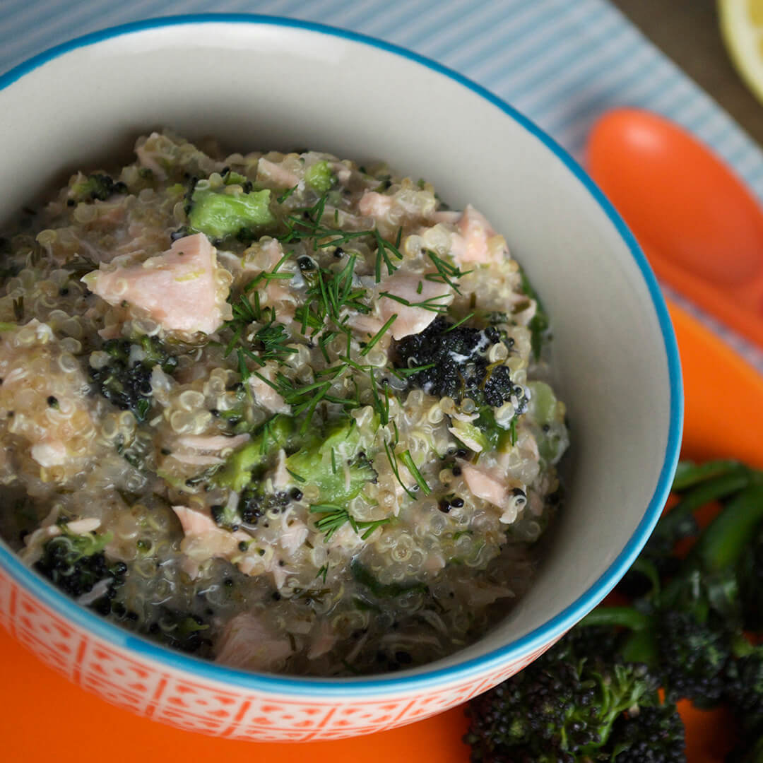 A bowl Salmon In A Creamy Lemon Dill Sauce with quinoa and purple sprouting broccoli