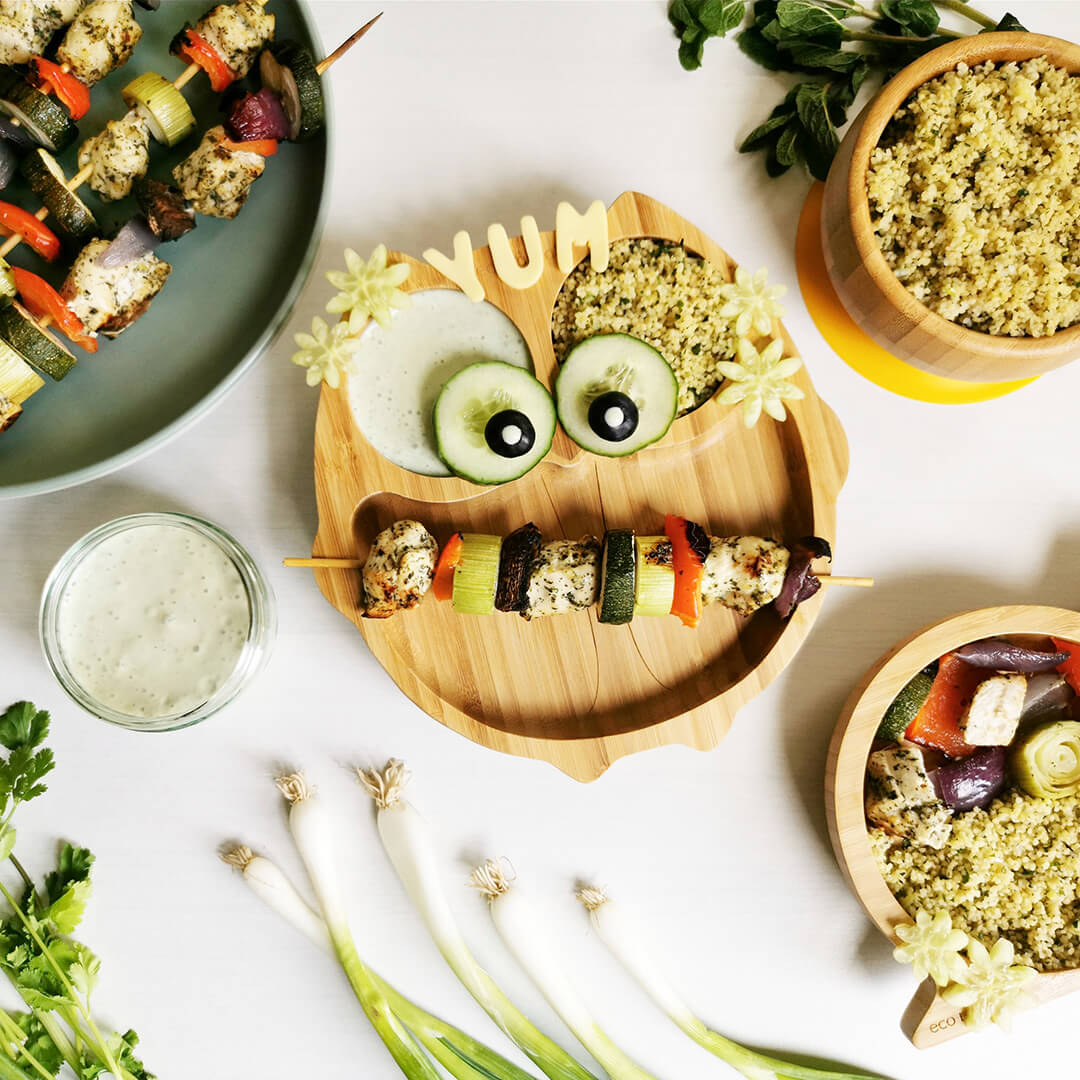 Tasty Chicken Kebabs & Couscous next to a plate of chicken kebabs and a bowl of couscous, a smaller serving of kebabs and couscous and a small dish of yoghurt dip