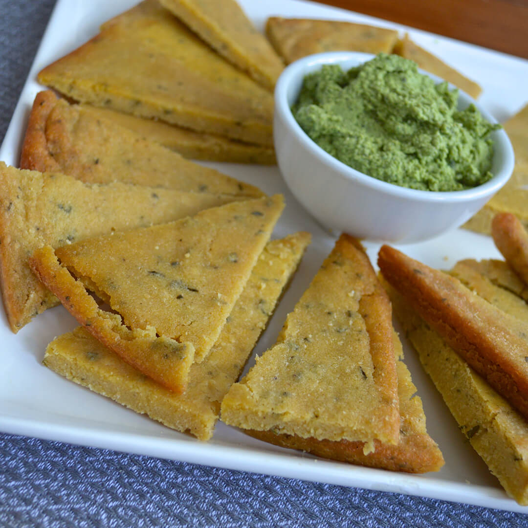 Farinata Flat Bread Triangles served with a green drip