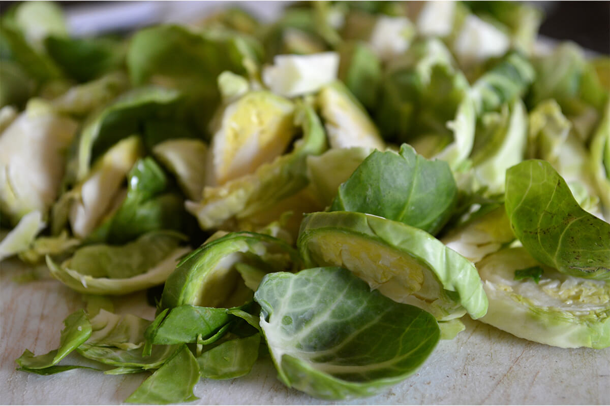 Finely chopped Brussels sprouts on a chopping board