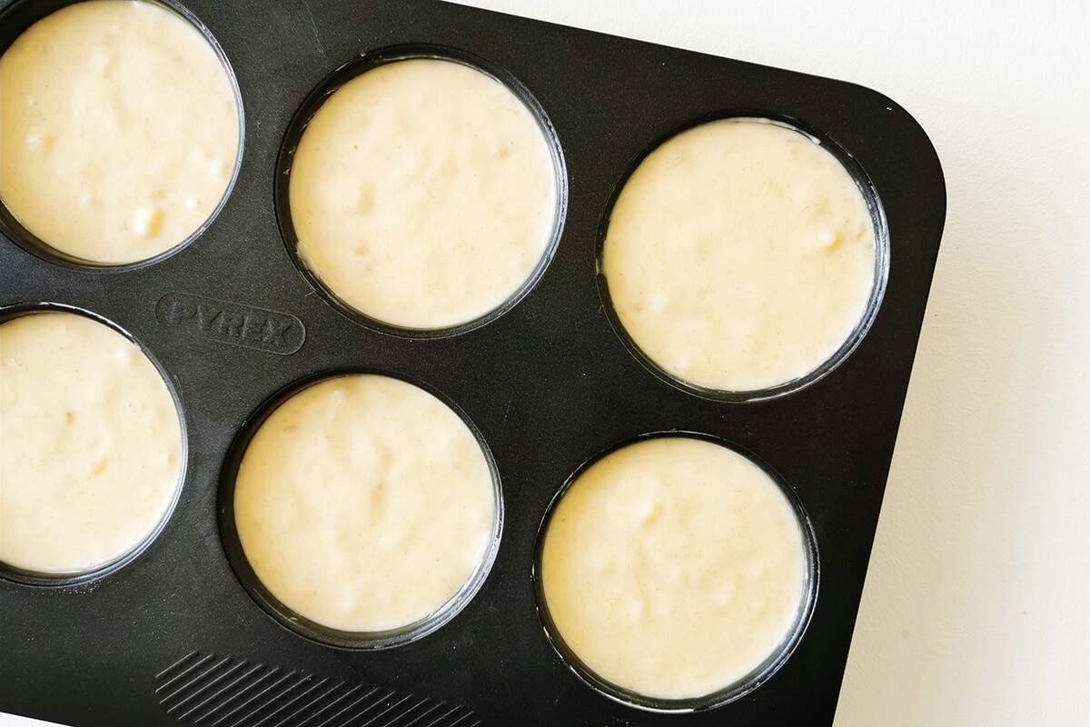 Baby banana muffin mix in muffin tin cups