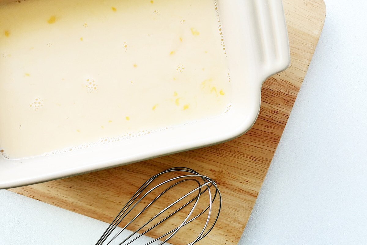 Whisked eggs and milk in a baking dish