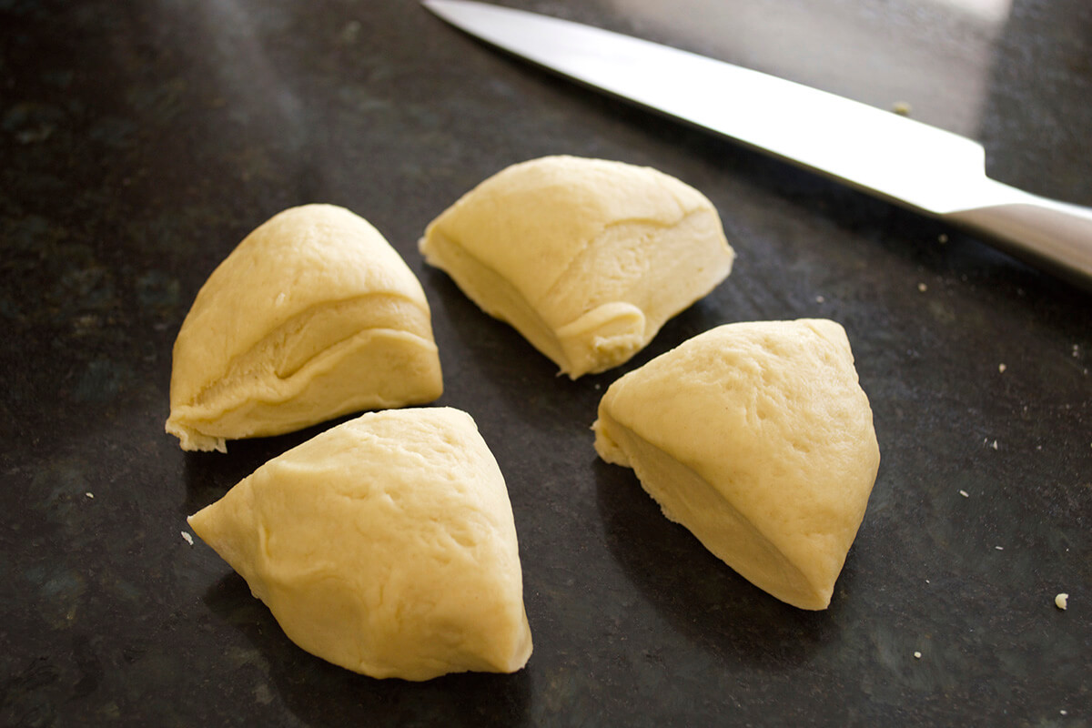 Pizza dough cut into quarters