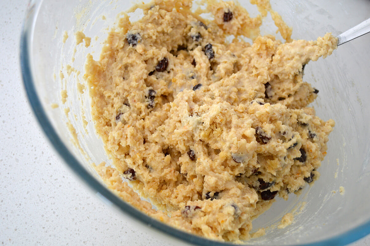 A glass bowl with hot cross muffin dough/batter