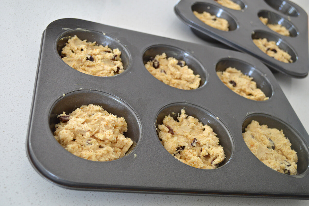 Hot cross muffin mixture in muffin tins