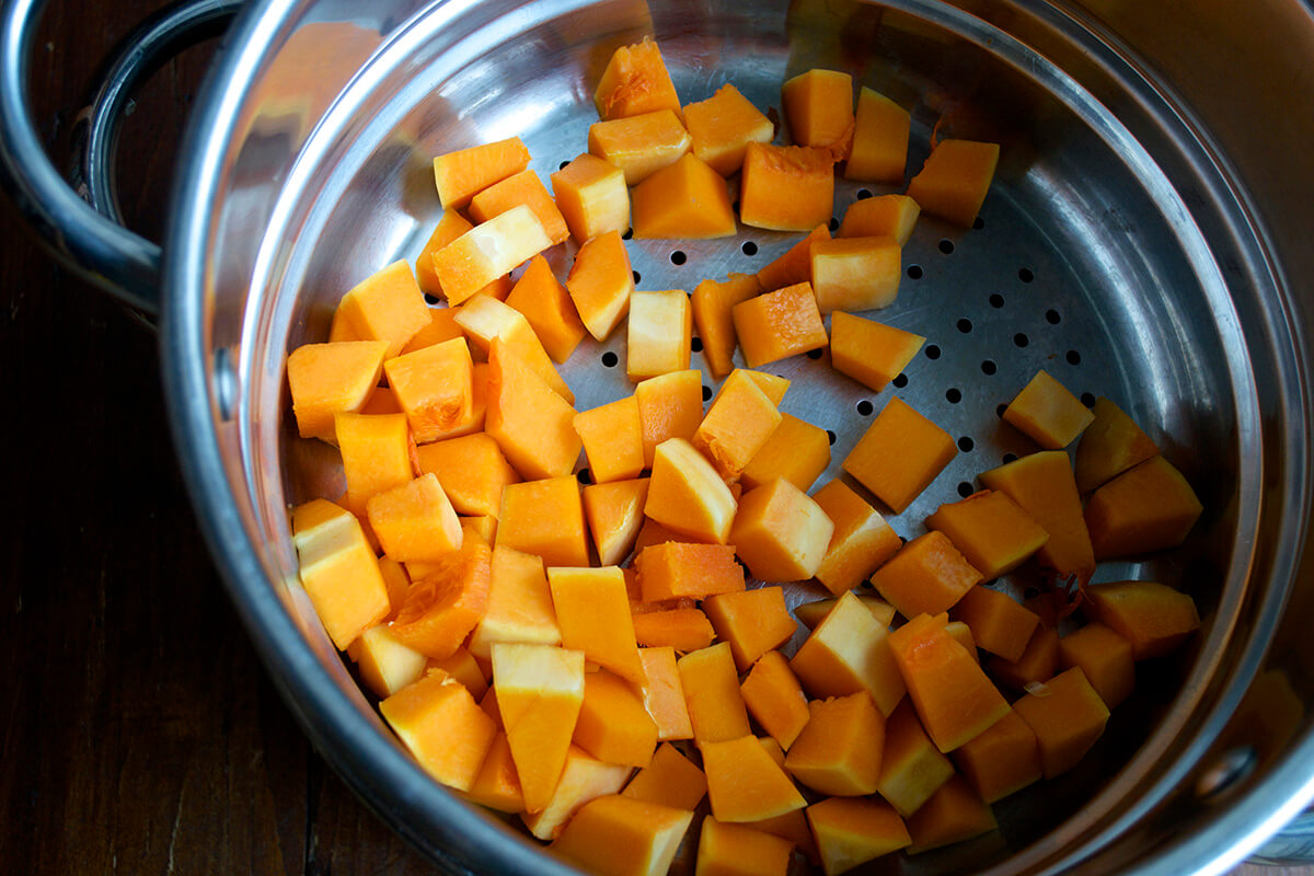 Diced butternut squash in a steamer