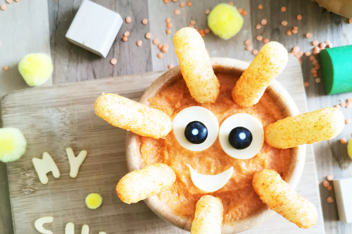 Organix melty carrot puffs are placed around the edges of the bowl